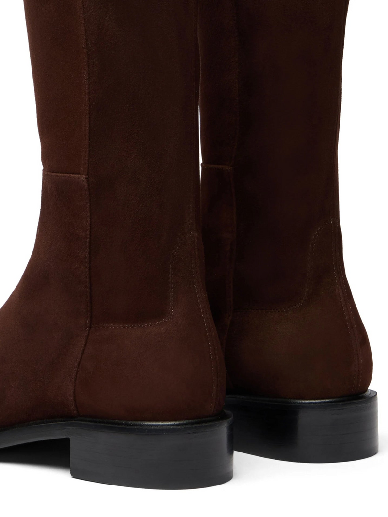 Brown knee-high boots on a white background