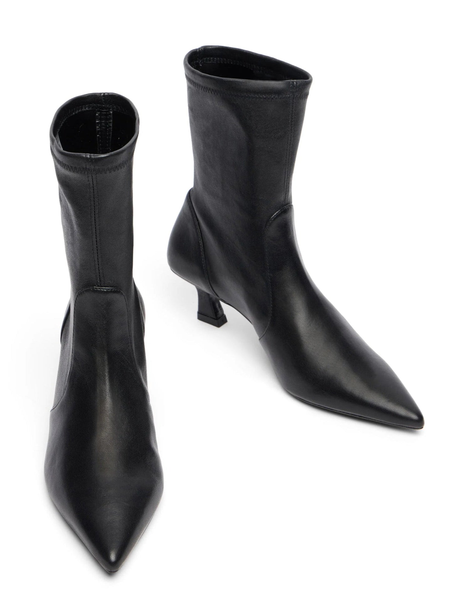 Pair of black ankle boots on a white background