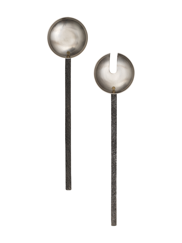 A pair of stainless steel salad servers with black handles and brass rivets.