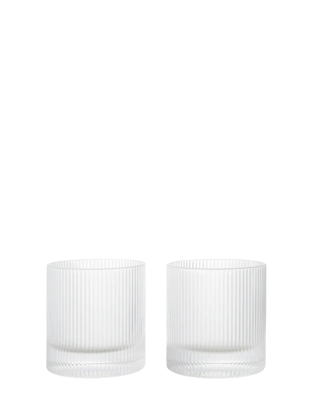 Two clear ribbed glass tumblers from Ferm Living's Ripple series on a white background