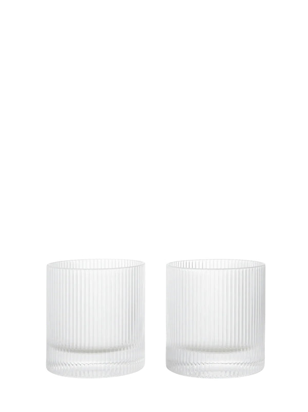 Two clear ribbed glass tumblers from Ferm Living's Ripple series on a white background