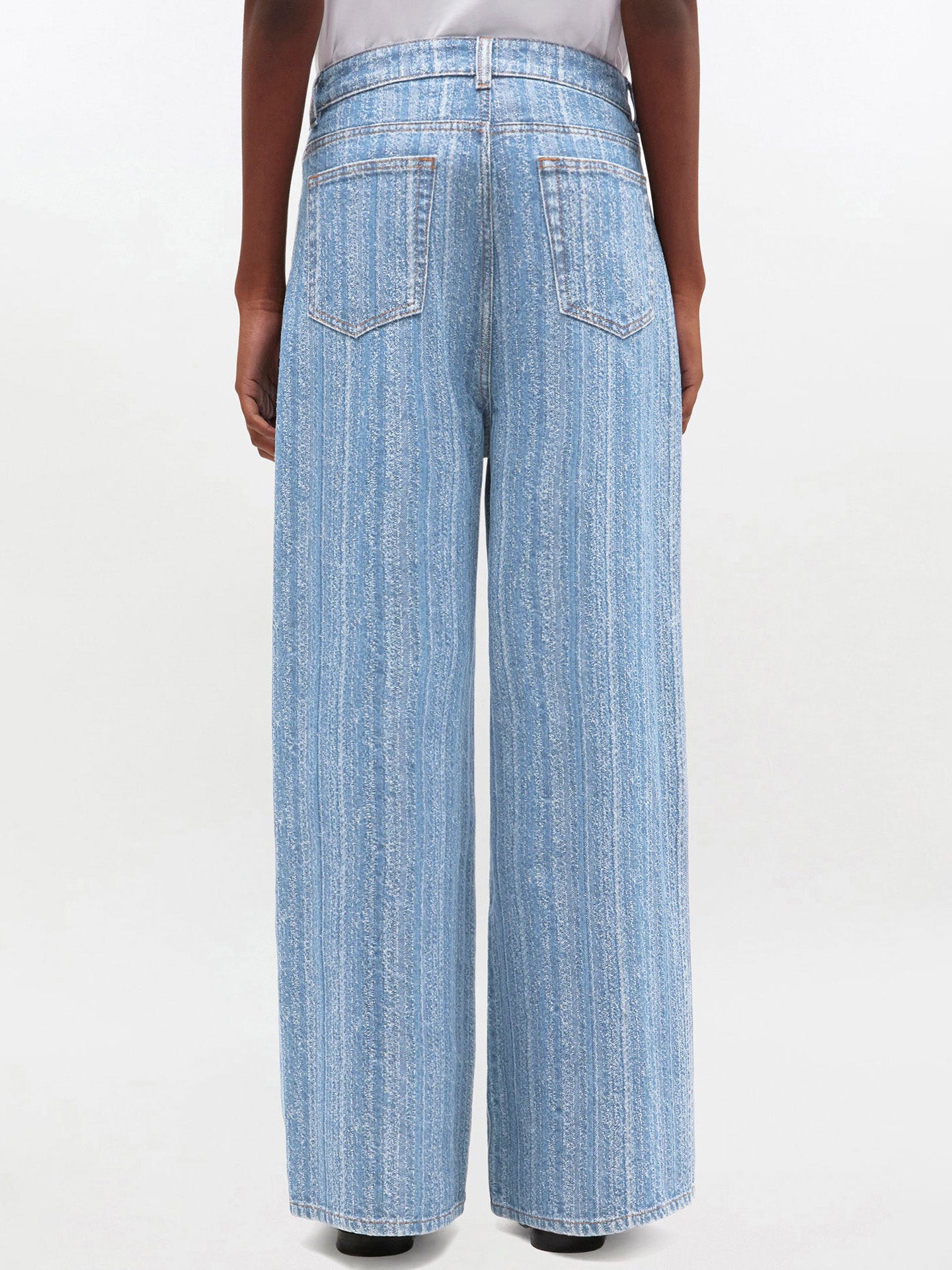 Light blue wide-leg jeans worn by a person on a white background