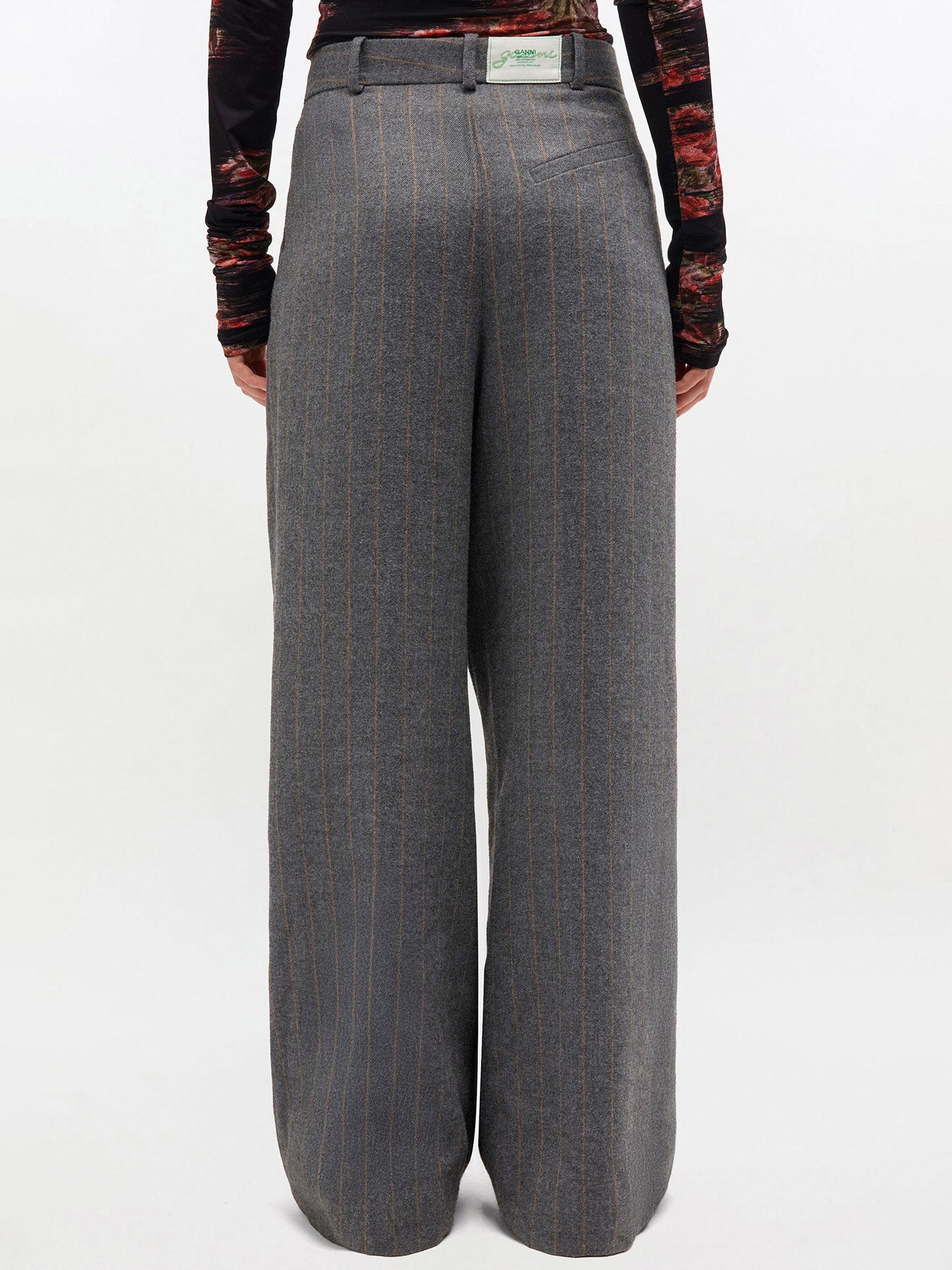 Gray pinstripe pants worn by a person on a white background