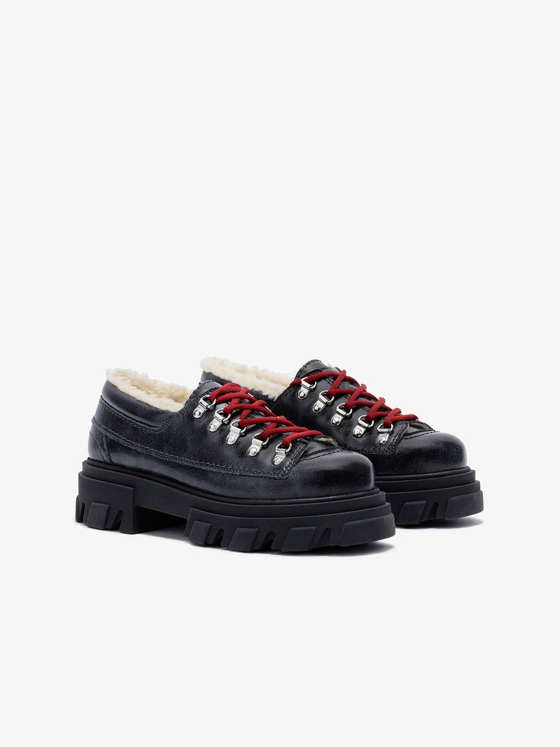 Grey leather shoes with red laces on a white background