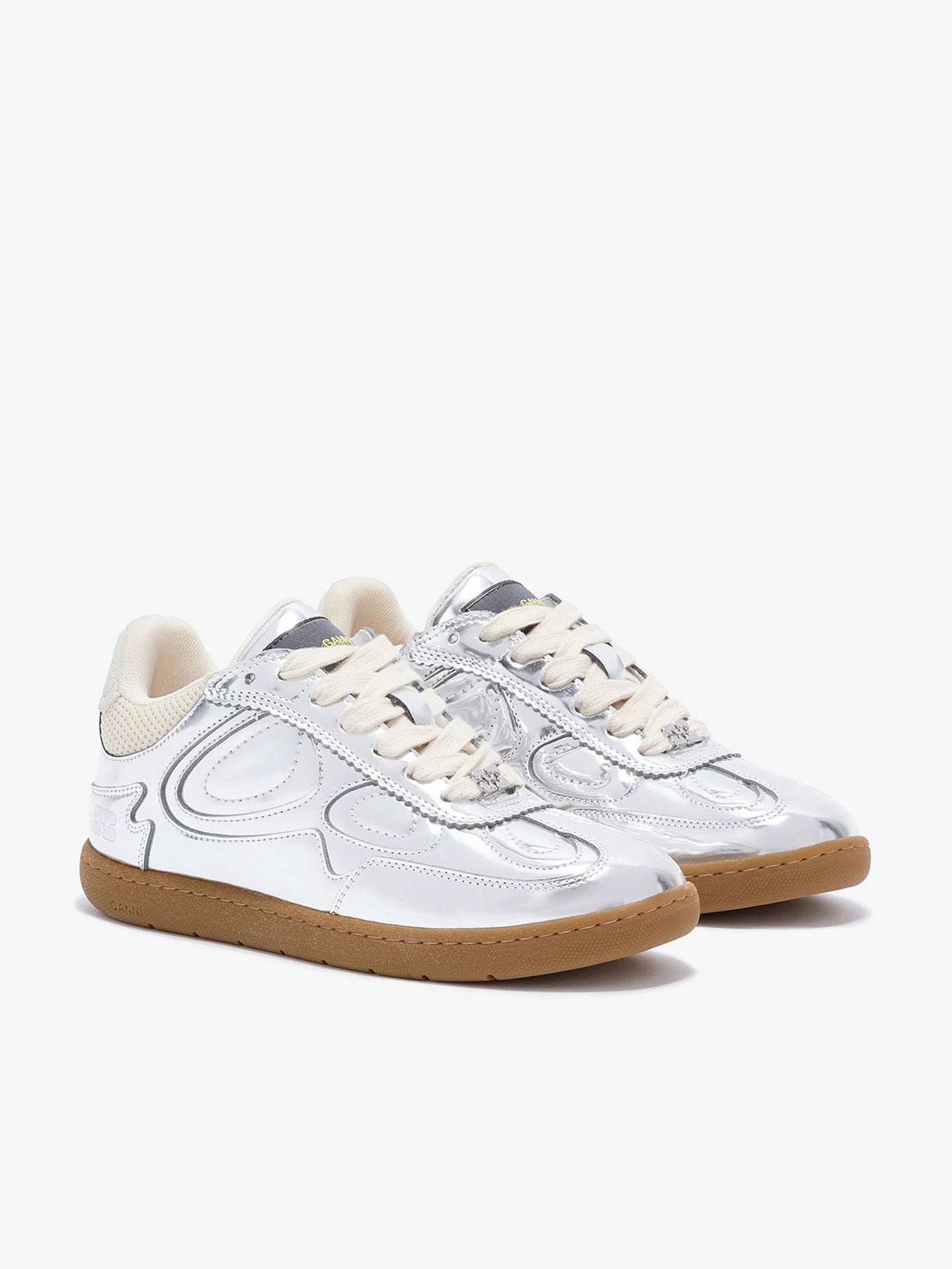 White sneakers with brown soles on a white background