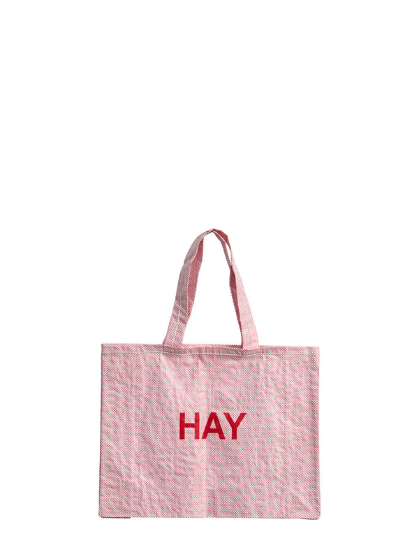 Pink tote bag with 'HAY' text on a white background