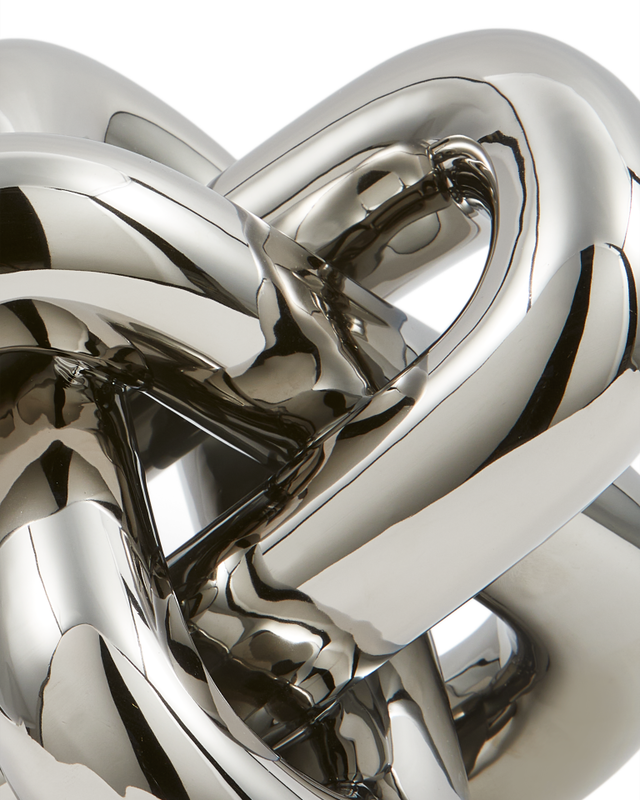 Close-up of a silver metal knot on a white background