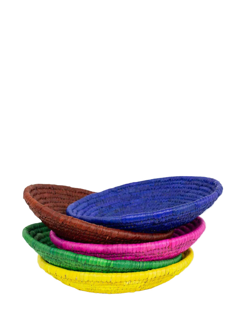 Stack of colorful woven palm baskets on a white background