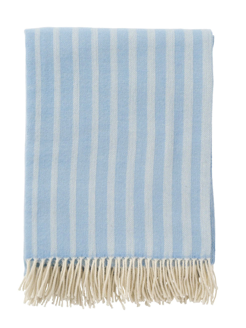 Striped blue and white blanket with fringes on a white background