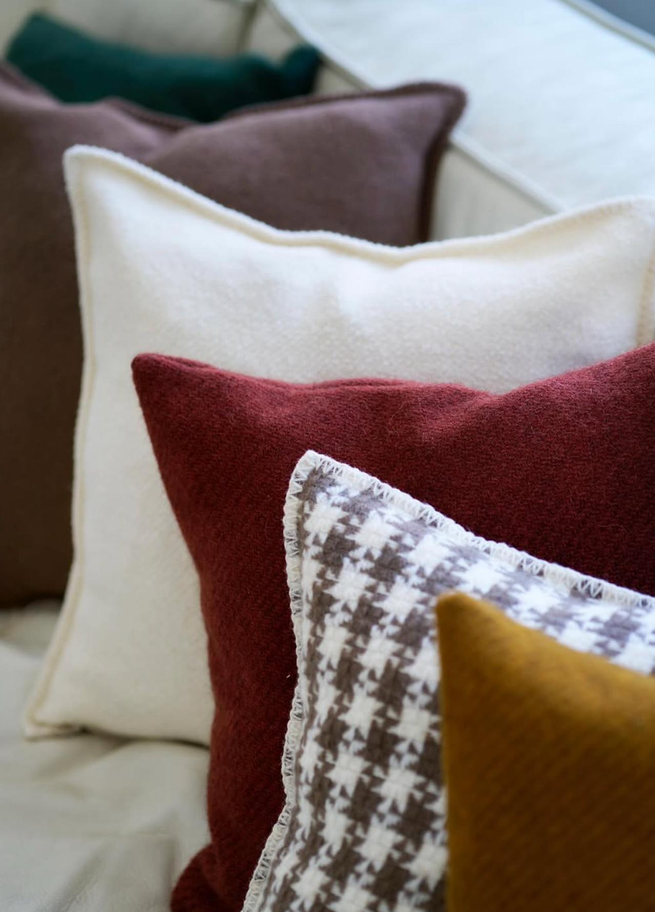 Close-up of various textured pillows on a sofa