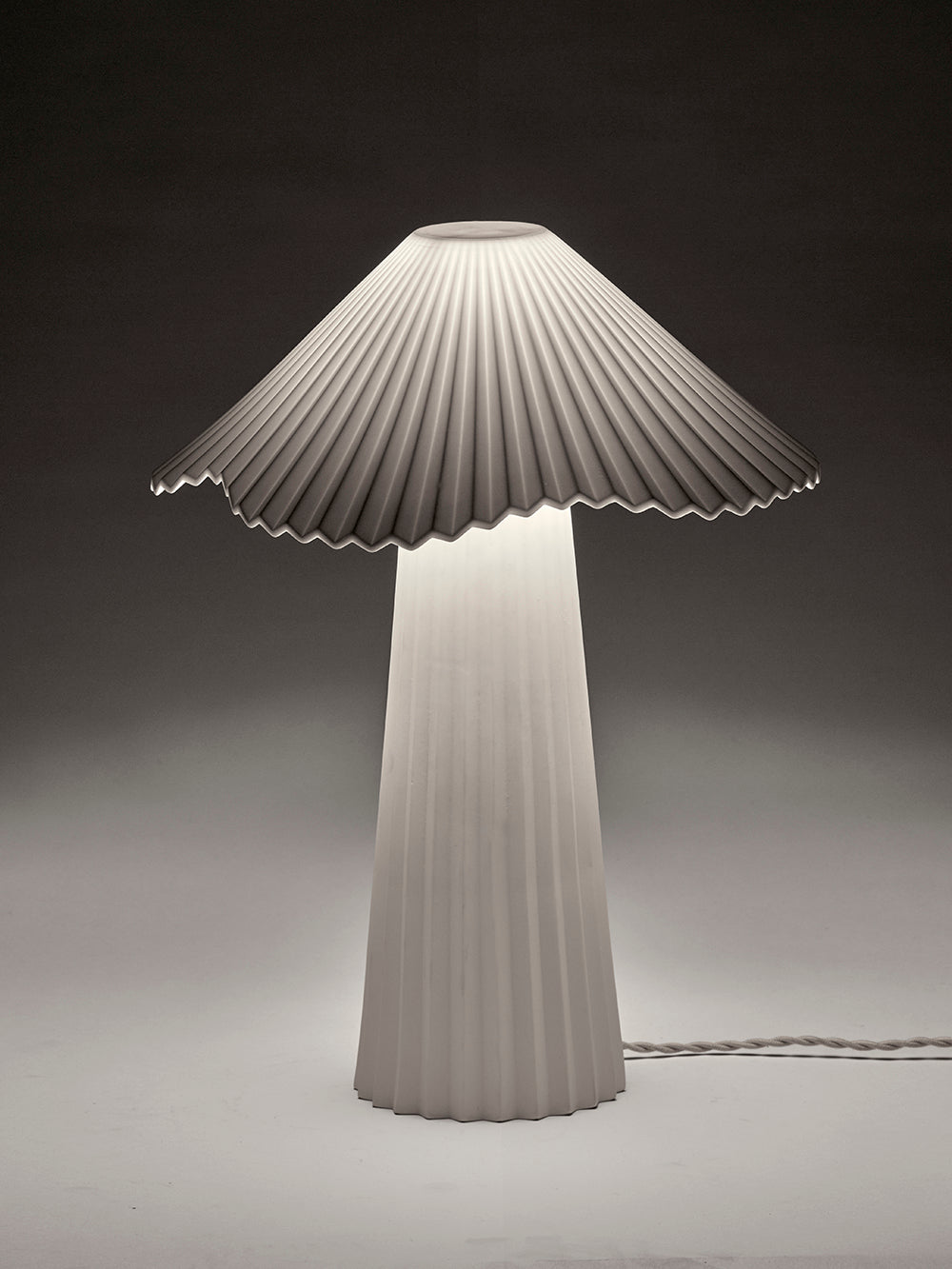 Modern lamp with pleated design on a dark background