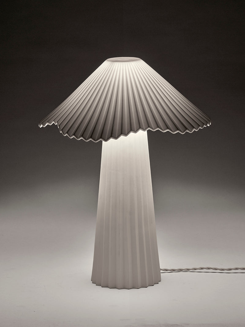 Modern lamp with pleated design on a dark background