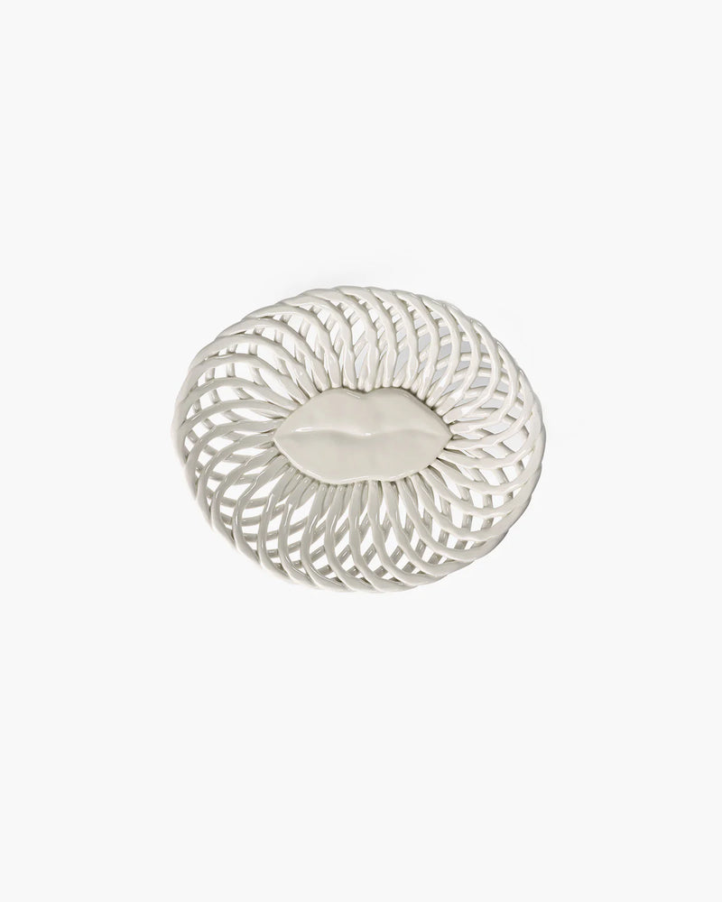 Decorative white plate with a leaf design on a white background