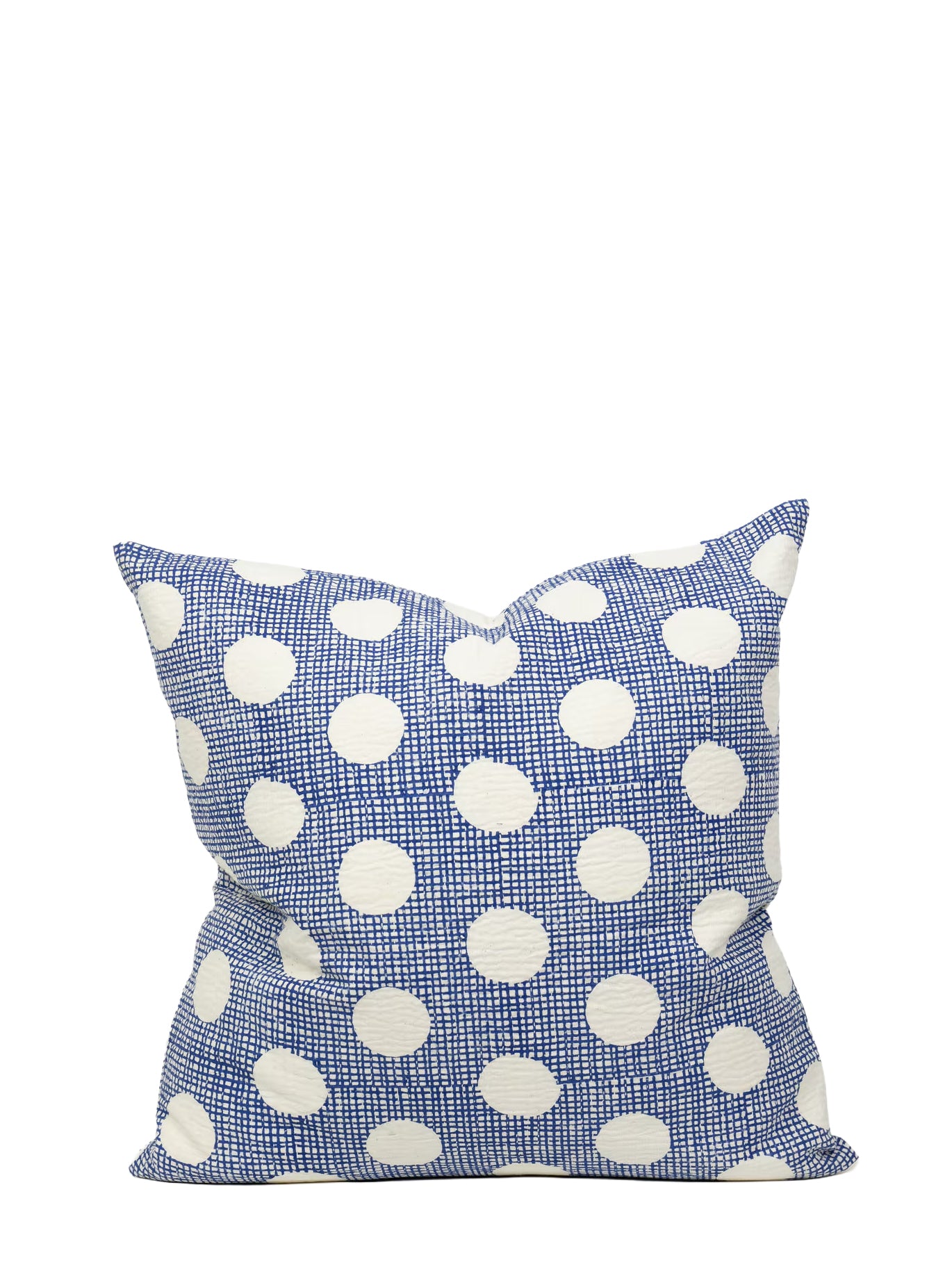 Blue pillow with white polka dots on a white background