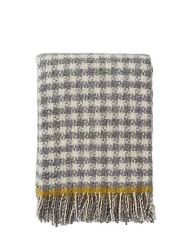 Plaid blanket with a yellow stripe and fringes on a white background