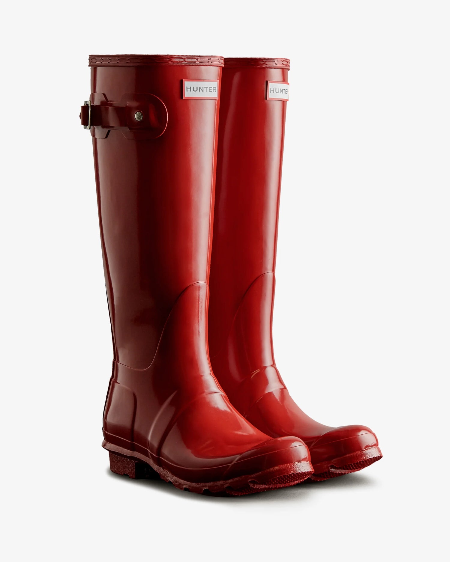 Pair of red Hunter rain boots on a white background