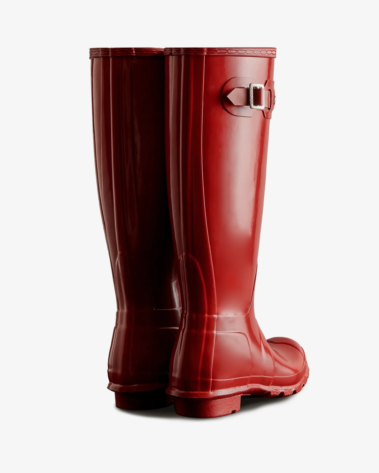 Pair of red rain boots on a white background