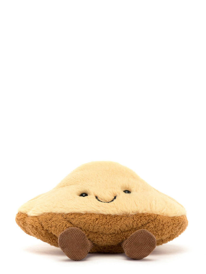 Plush toy resembling a pie with a smiling face on a white background