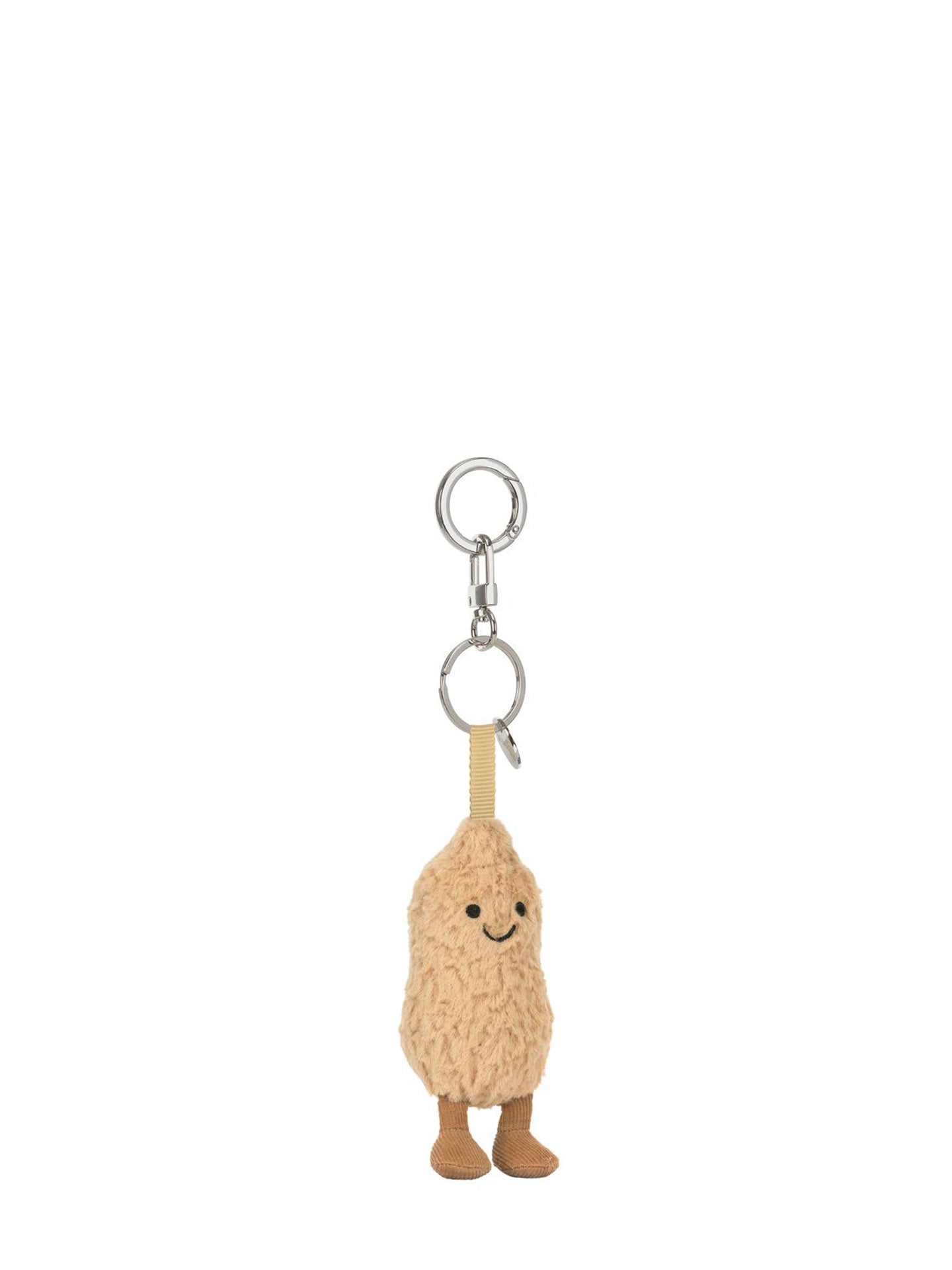 A small plush peanut character keychain with a smiling face, black embroidered eyes and mouth, tan feet, and silver metal key rings on a plain white background.
