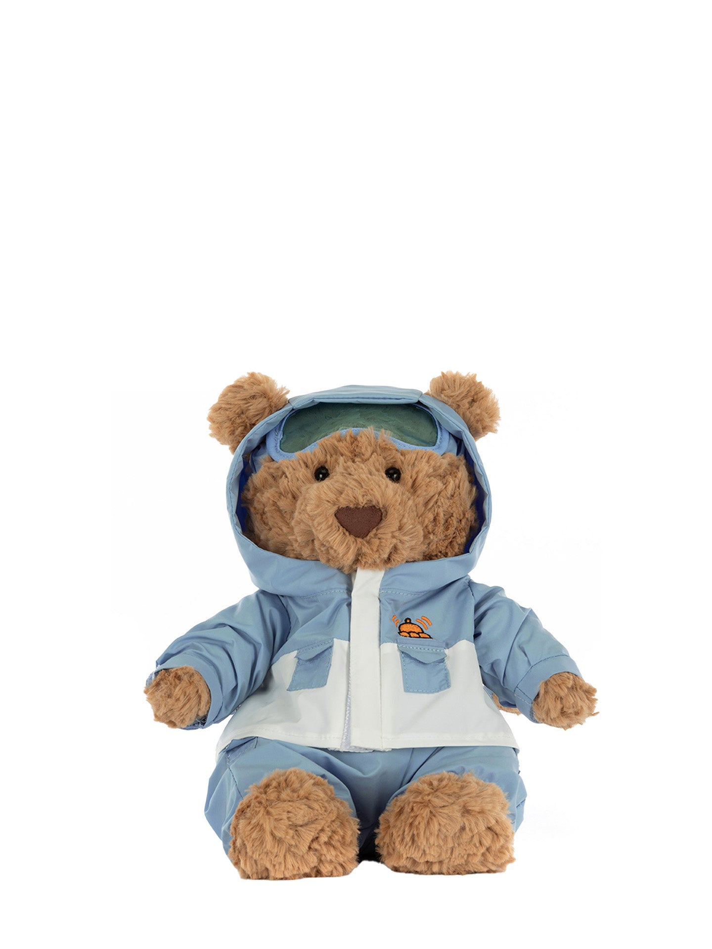 Plush teddy bear wearing a blue snowsuit on a white background