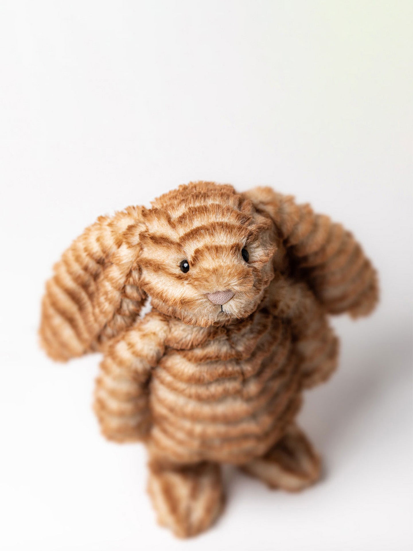 Bashful Juniper Luxe bunny is a brown rabbit plush toy on grey backround