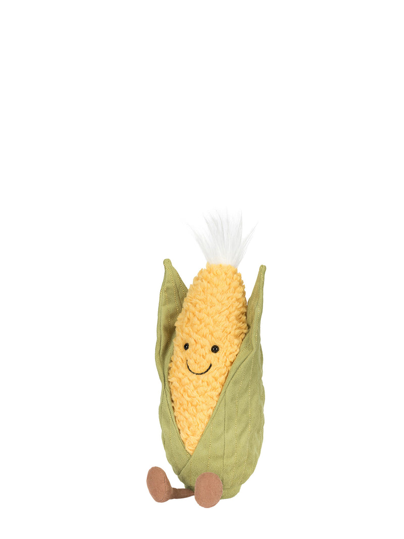 Plush toy resembling a corn on the cob with a smiling face on a white background