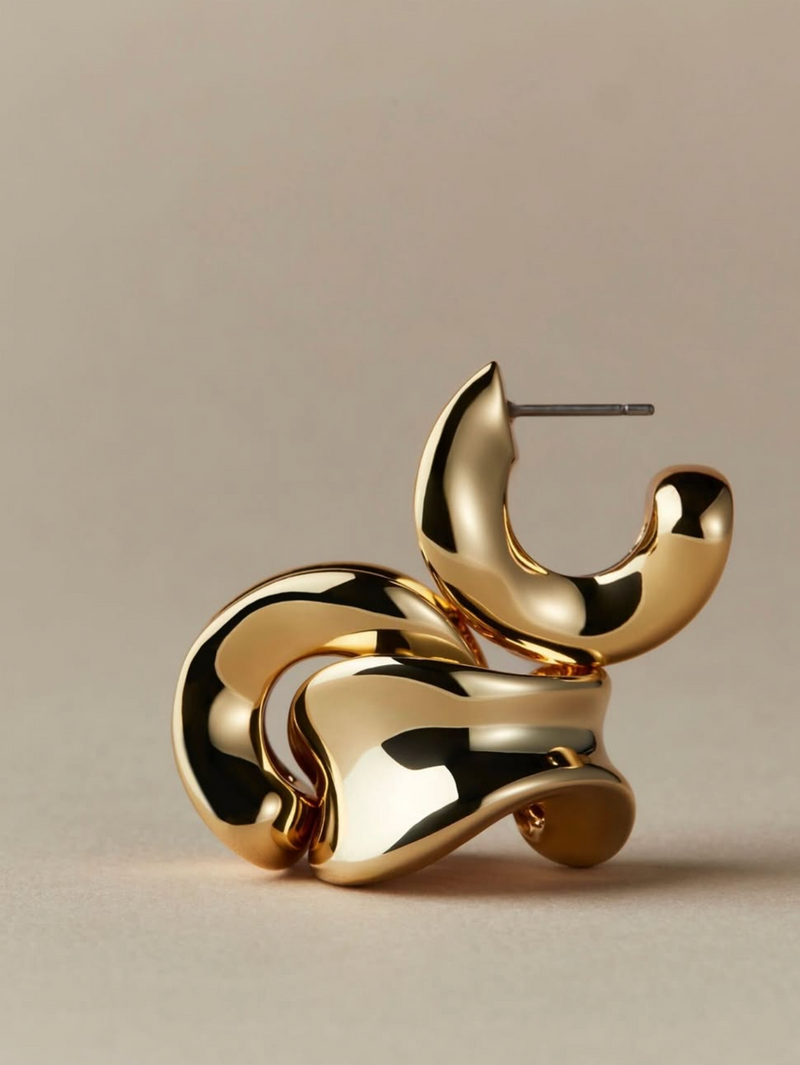 Gold earrings on a beige background