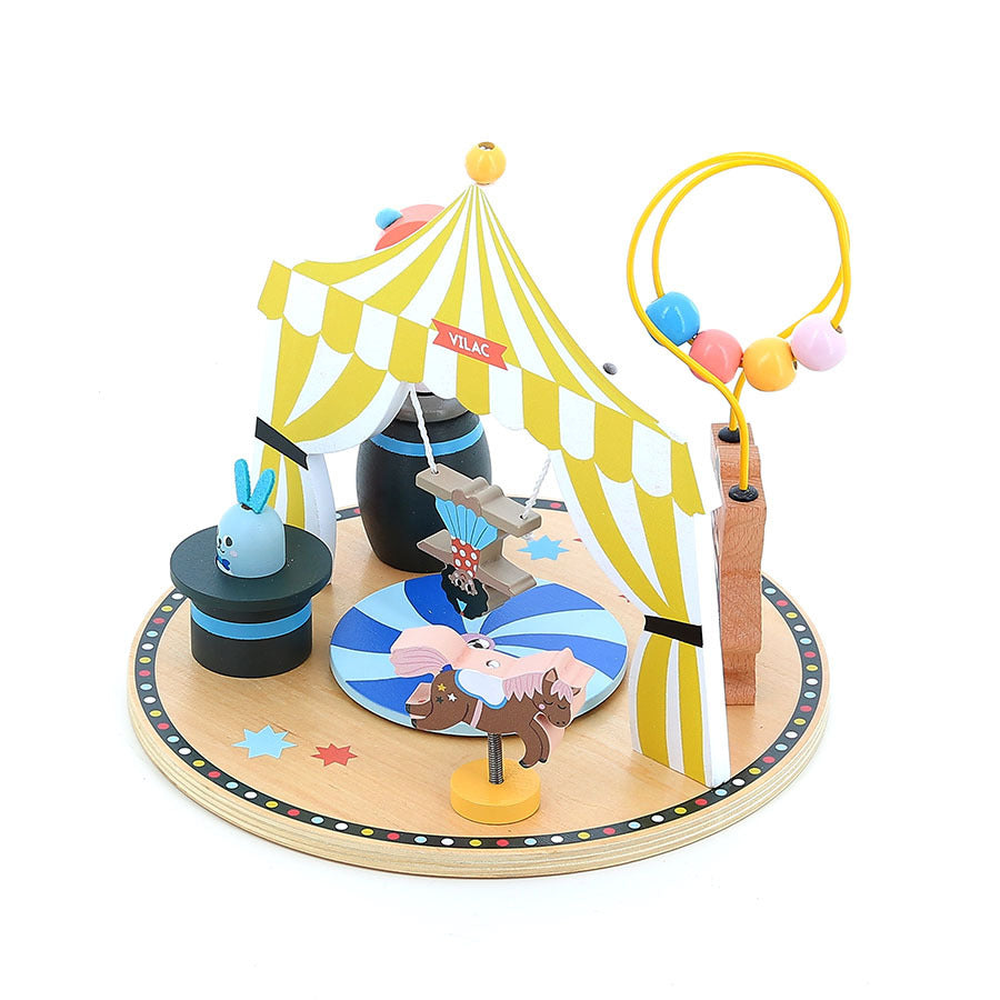 Toy circus set with colorful tent, animals, and props on a white background