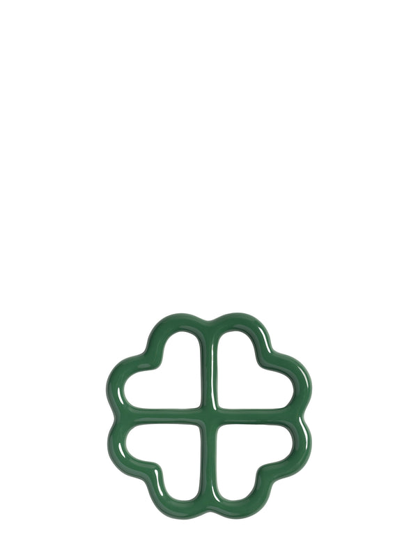 A dark green four-leaf clover shaped ceramic trivet, shown from upward on a plain white background.