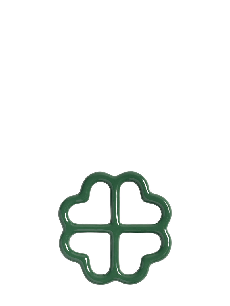 A dark green four-leaf clover shaped ceramic trivet, shown from upward on a plain white background.