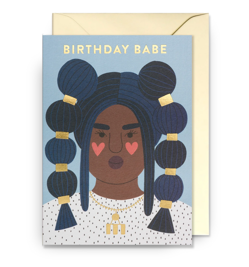Illustrated birthday card with a female character with heart-shaped elements, and the text 'BIRTHDAY BABE' on a blue background. Includes a matching envelope.