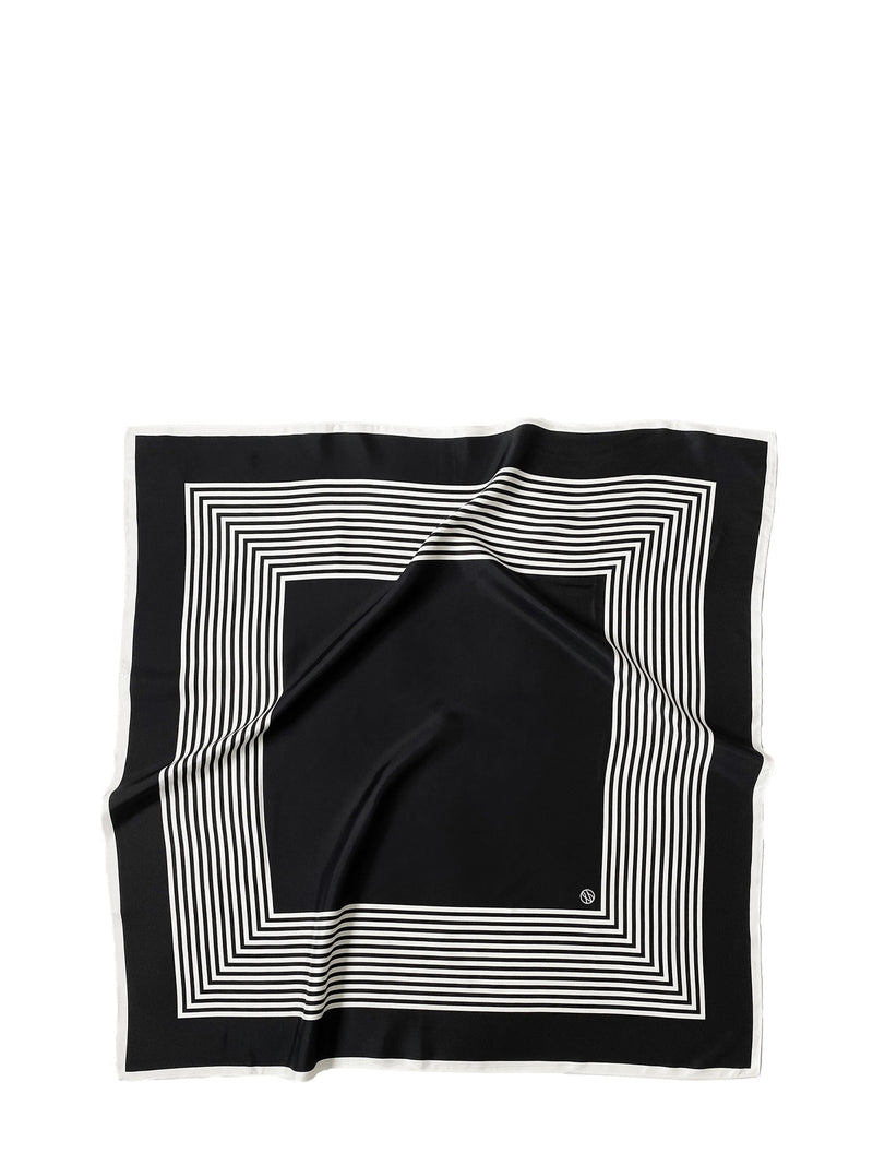 A square black silk scarf with a white geometric border pattern of concentric stripes, laid flat on a white background.