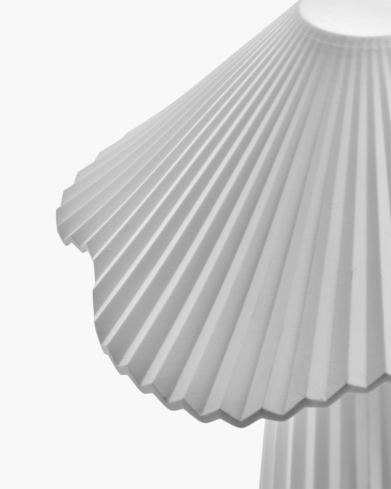 Close-up of a pleated skirt with a white background