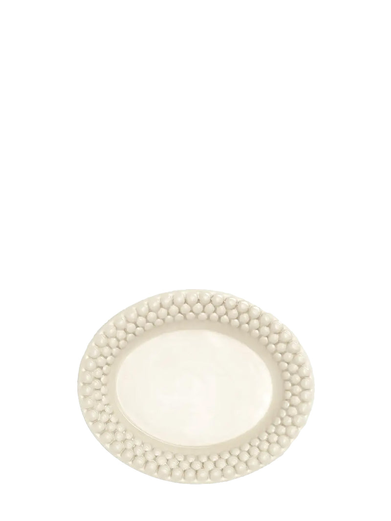 White ceramic plate with decorative pearl-like border on a white background