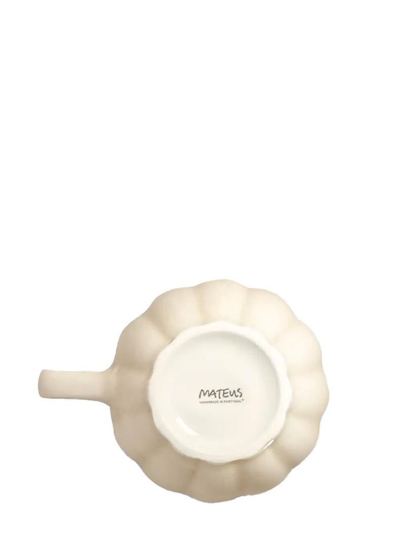 Cream-colored mug bottom with 'Mateus' branding on a white background