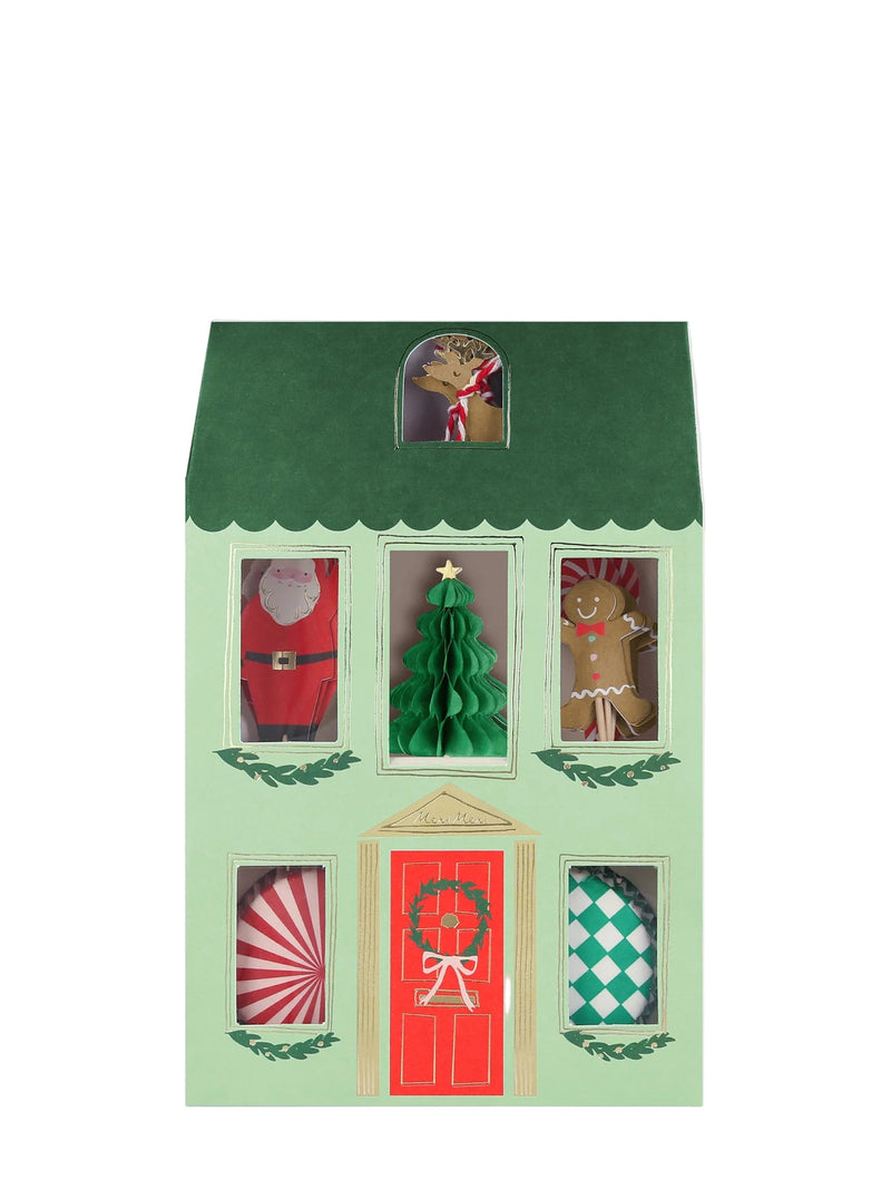 Decorative house-shaped box with Christmas-themed characters on the windows, Santa on top row, Christmas tree at the middle and gingerbread man on the right upper corner and Rudolf the reindeer peeping from the tiny attic window, photographed on a white background