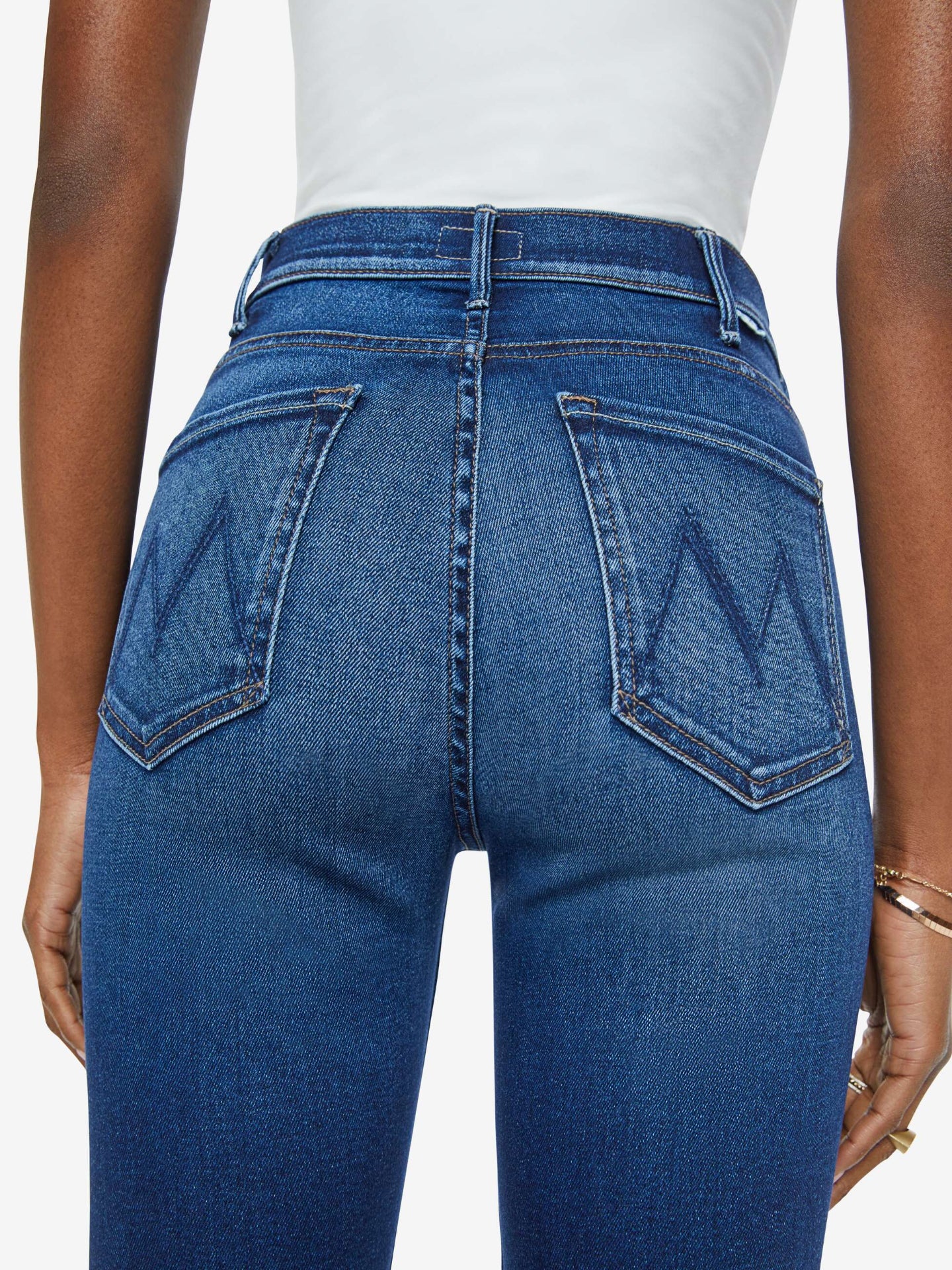 Blue jeans worn by a person on a white background