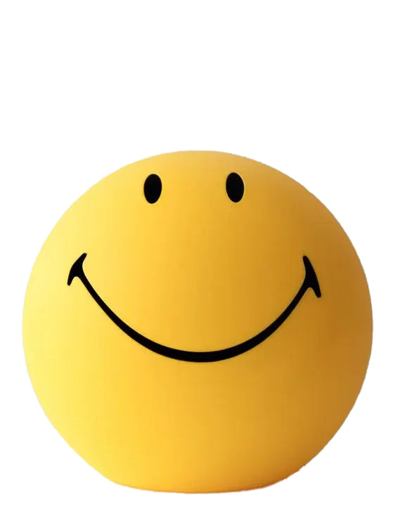 A bright yellow Smiley floor lamp with a tilted face, designed to emit a warm glow.