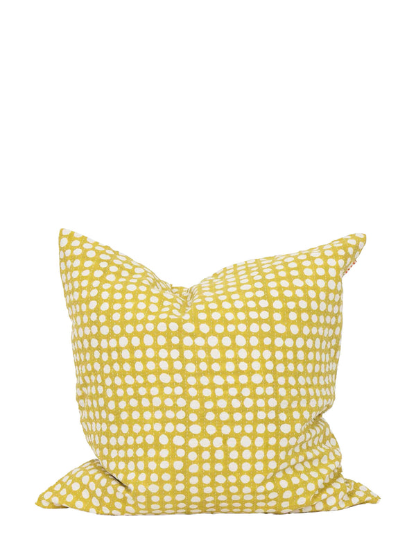 A square throw pillow in a mustard yellow fabric with a white hand-drawn polka dot pattern, shown against a plain white background.