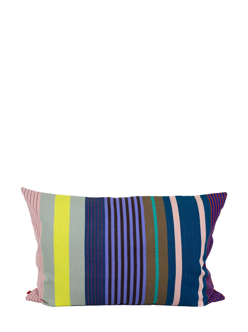A rectangular throw pillow with a colorful vertical striped pattern, featuring shades of navy, purple, pink, yellow, and green, set against a plain white background.