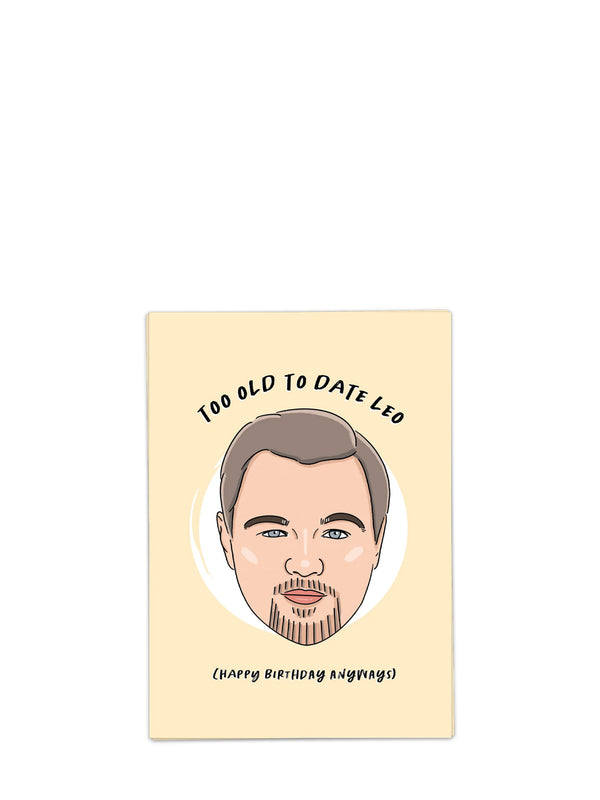 Greeting card with a caricature of a man's face and text 'Too Old to Date Leo (Happy Birthday Anyway)' on a beige background.