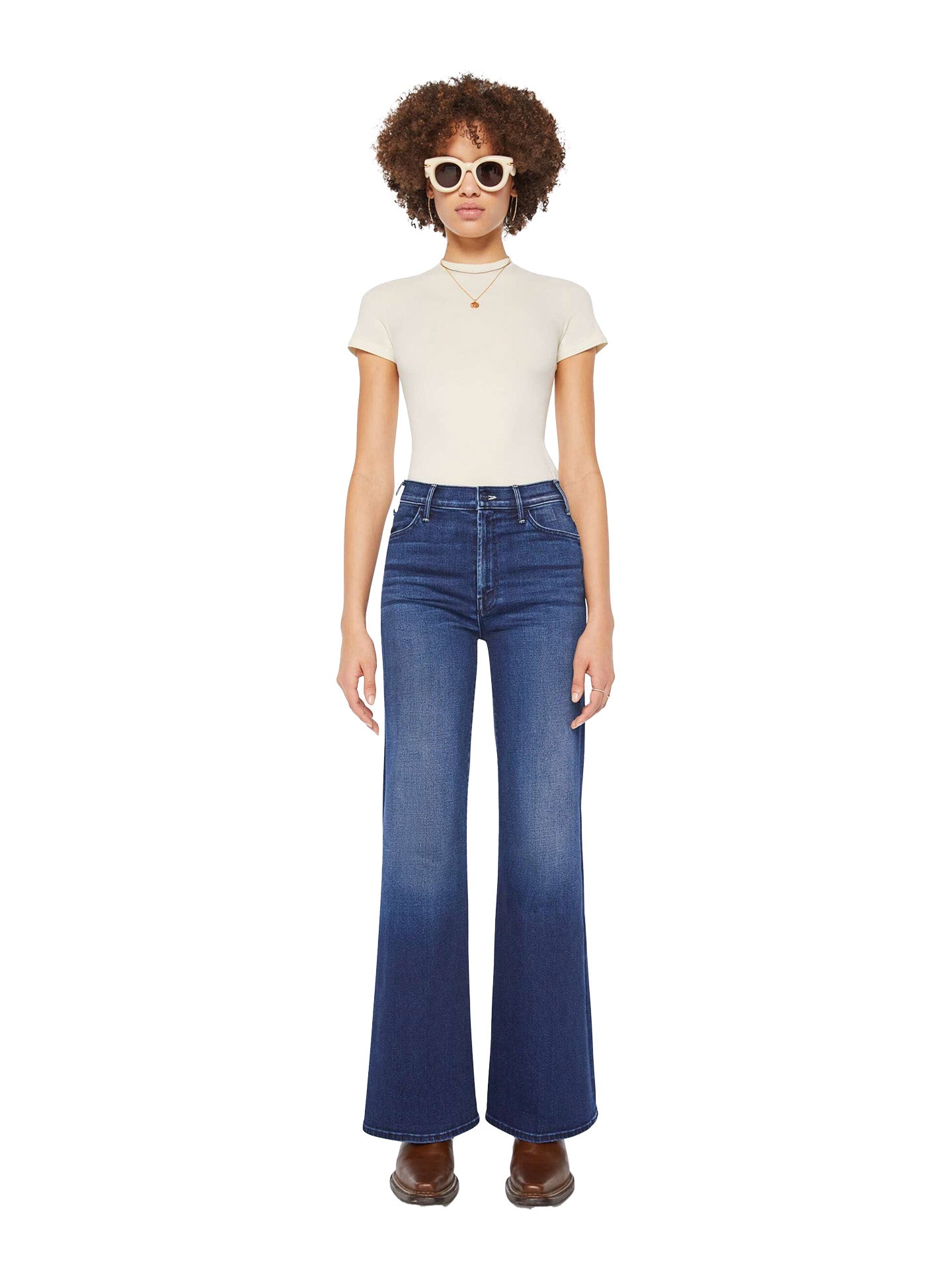 Model wearing a white t-shirt and blue Mother jeans on a white background