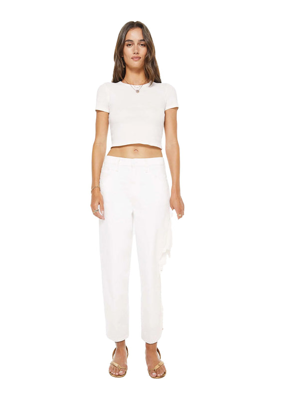 Woman wearing a white crop top and wide-leg Mother pants on a white background