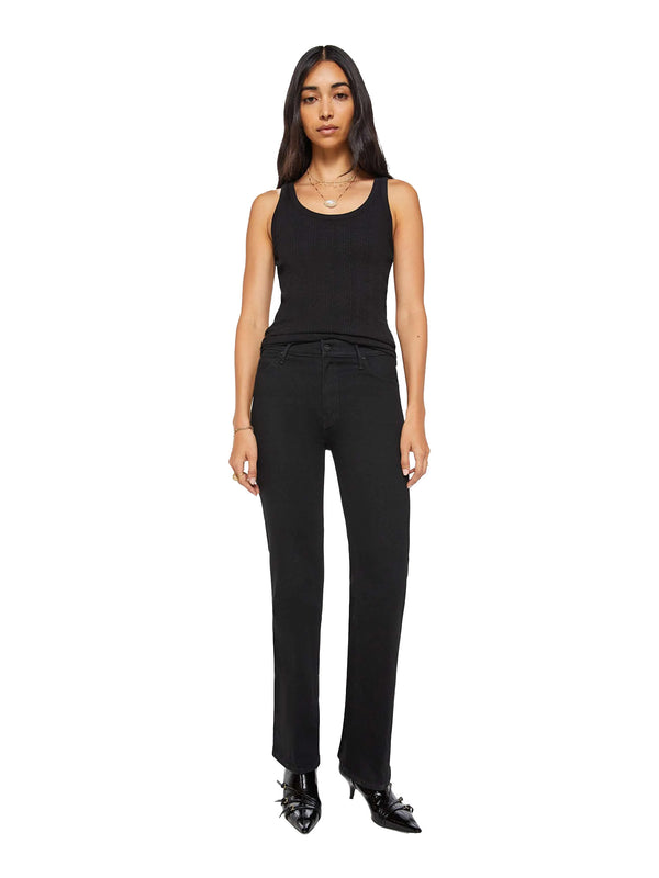 A woman modeling a black sleeveless tank top and black straight-leg pants with black pointed-toe heels, photographed against a plain white studio background.