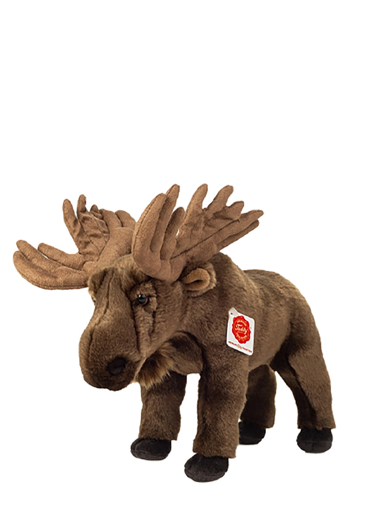 A brown plush moose toy with large antlers and a small red-and-white sewn label on its side, photographed on a plain white background.