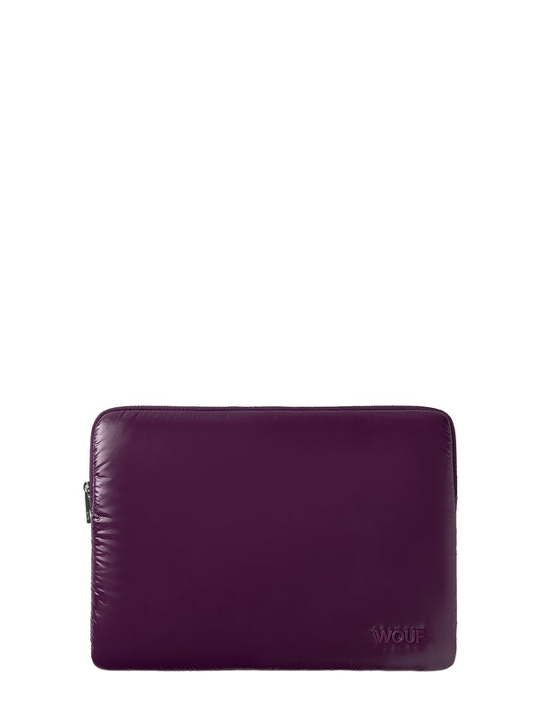 A dark purple leather laptop sleeve with a small debossed 'WOUR' logo on the bottom right corner, shown against a plain white background.