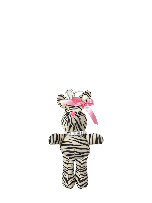 Plush zebra toy with a pink bow on a white background
