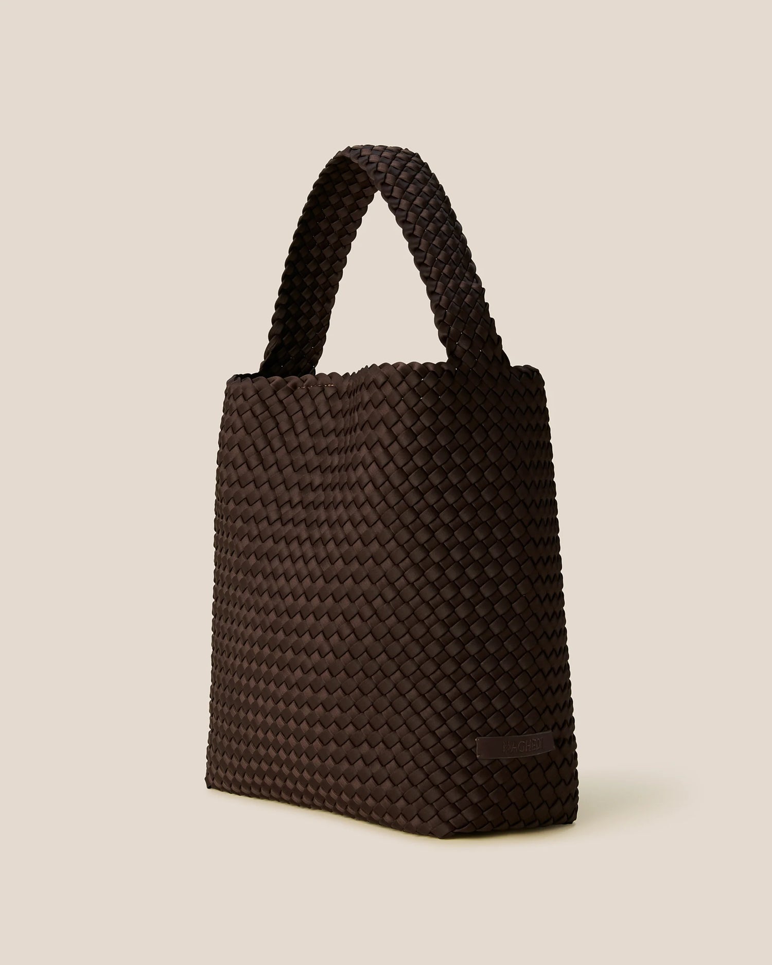Brown woven handbag on a beige background