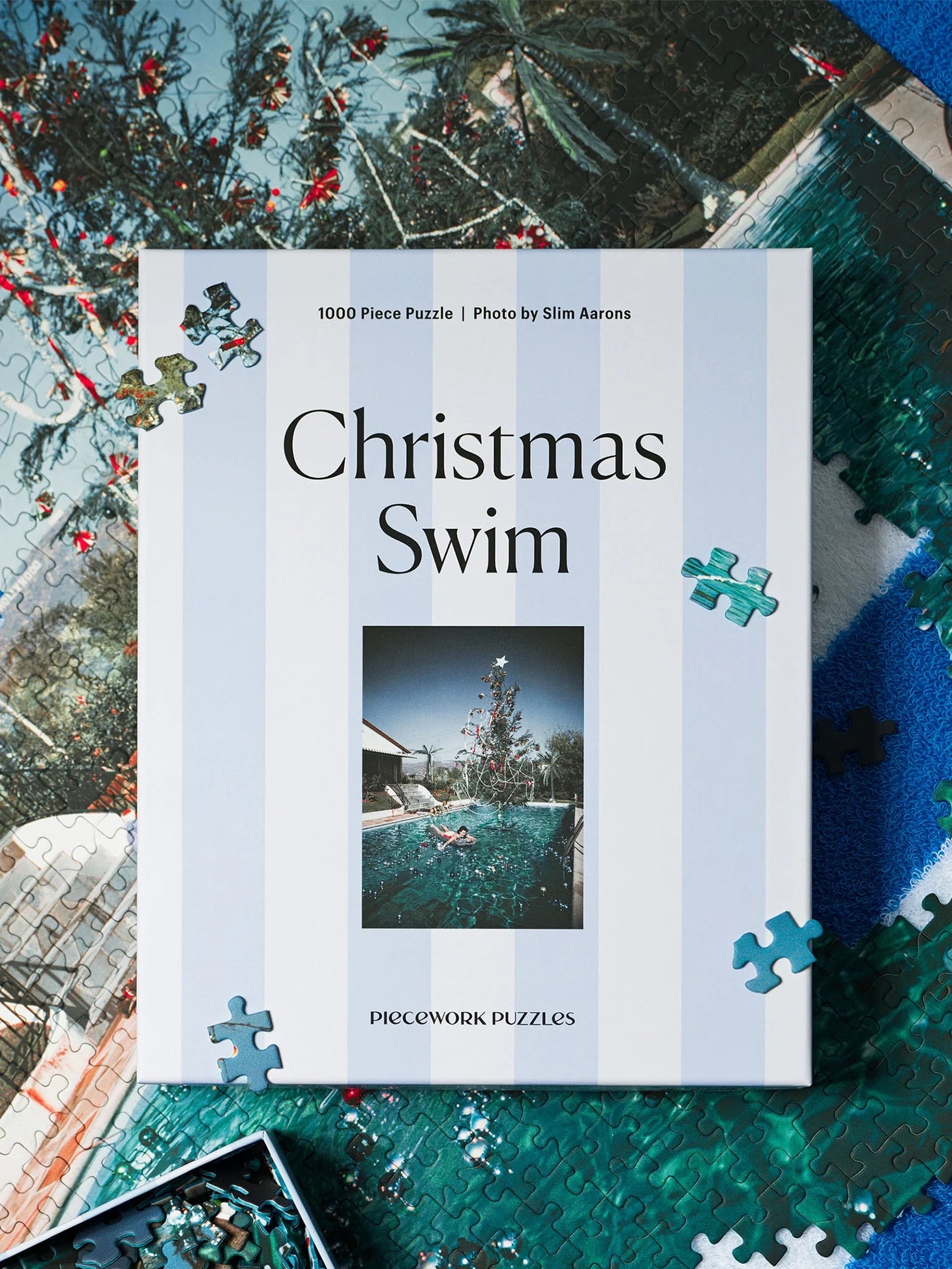 Jigsaw puzzle box titled 'Christmas Swim' with a pool scene on a decorative background.