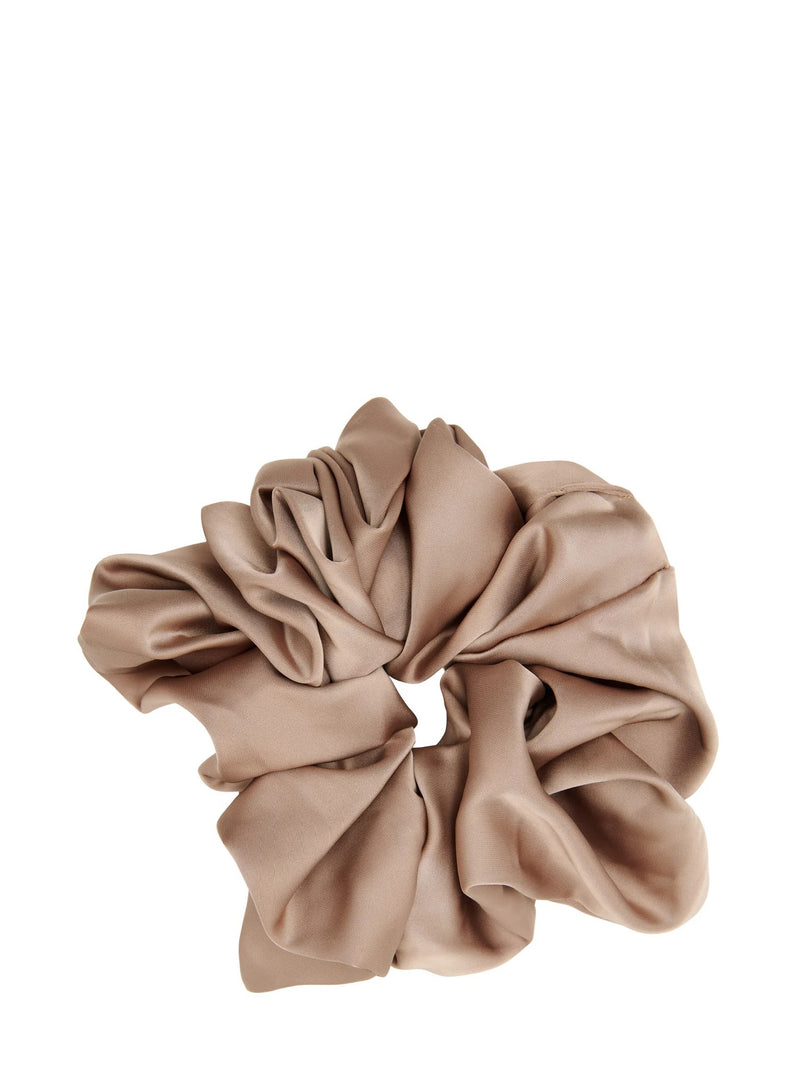 A single satin-like scrunchie in a warm taupe-beige color, photographed against a solid white background.